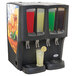 A Crathco refrigerated beverage dispenser with different colored drinks in the bowls.