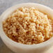 A bowl of food on a marble surface with 32 oz. Minced Garlic in Water.