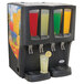 A Crathco refrigerated beverage dispenser with four different drinks in clear bowls with fruit decals.