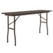 A brown rectangular Correll folding table with metal legs.