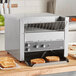 A Vollrath conveyor toaster with toasted bread inside.