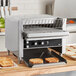 A Vollrath JT2000 conveyor toaster on a counter with toasted bread on a rack.