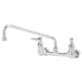 A T&S chrome wall mounted pantry faucet with lever handles and a swing spout.