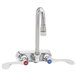 A T&S chrome wall mount faucet with two 4" wrist handles.