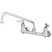 A T&S chrome wall mounted pantry faucet with lever handles.
