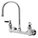 A close-up of a silver T&S wall mount pantry faucet with two lever handles.