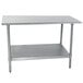 An Advance Tabco stainless steel work table with undershelf.