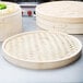 A Town bamboo steamer cover with a woven pattern.
