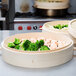 Town bamboo steamers with food in them on a table in an Asian cuisine restaurant.