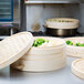 A group of Town bamboo steamers with food in them.