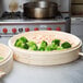 A Town bamboo steamer set with trays of broccoli and shrimp.