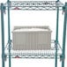 A gray plastic Metro tote box on a metal shelf.