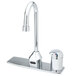 A T&S chrome deck mounted hands-free sensor faucet with a gooseneck spout above a chrome sink.