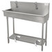 A stainless steel Advance Tabco multi-station hand sink with faucets.