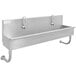 An Advance Tabco stainless steel multi-station sink with two faucets.