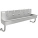 A stainless steel Advance Tabco multi-station hand sink with 5 electronic faucets.