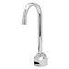A close-up of a silver T&S hands-free sensor faucet with a black button.
