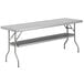A Regency stainless steel folding work table with shelf.