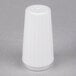 A white prefilled disposable salt shaker on a gray surface.