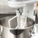 A close up of a white KitchenAid flat beater.