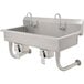 An Advance Tabco stainless steel multi-station hand sink with knee operated faucets.