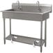 A stainless steel Advance Tabco hand sink with 5 toe operated faucets.