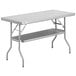 A gray rectangular Regency stainless steel folding table with a shelf.