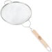 A Tablecraft medium tin single mesh strainer with a wooden handle.