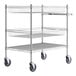 A Regency chrome metal cart with two baskets and a shelf on wheels.