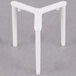 A white plastic pizza saver on a table.