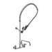 A chrome Equip by T&S wall mounted pre-rinse faucet with a hose attachment and lever handles.