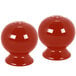 A pair of red Fiesta salt and pepper shakers.