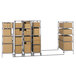 A Metro chrome metal double deep mobile shelving unit with boxes on wheels.