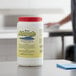 A white container of Noble Chemical Absorb on a counter.