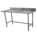 An Advance Tabco stainless steel work table with a backsplash.