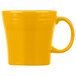 A yellow coffee mug with a handle.