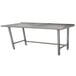 A stainless steel Advance Tabco work table with a long metal surface and legs.