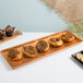 A Chicago Metallic copper bakery display tray with pastries and muffins on it.