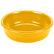 A yellow Fiesta china bowl with a white background.