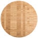 An American Metalcraft bamboo round cutting board on a table.