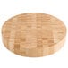 An American Metalcraft bamboo round cutting board on a table.