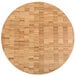 An American Metalcraft bamboo round cutting board on a table.