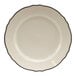 A white circular china bread and butter plate with black scalloped trim.