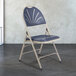 A gray metal National Public Seating folding chair with a dark blue plastic seat.