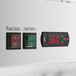A control panel with a power switch, light switch, and digital temperature display on a white Avantco GDC-49-HC glass door merchandiser refrigerator.