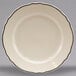 A white Homer Laughlin china plate with black trim on the scalloped edges.