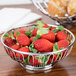 A stainless steel American Metalcraft round basket filled with strawberries.