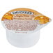 A white Smucker's Sugar Free Breakfast Syrup portion cup with a brown label.