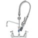 A chrome T&S pre-rinse faucet with a silver hose attached.