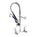A chrome T&S wall mounted pre-rinse faucet with hose and swivel.